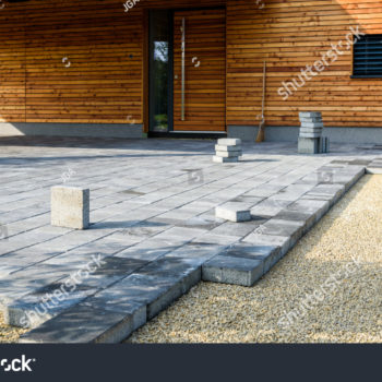 stock-photo-laying-gray-concrete-paving-slabs-in-house-courtyard-driveway-patio-professional-workers-1184163673